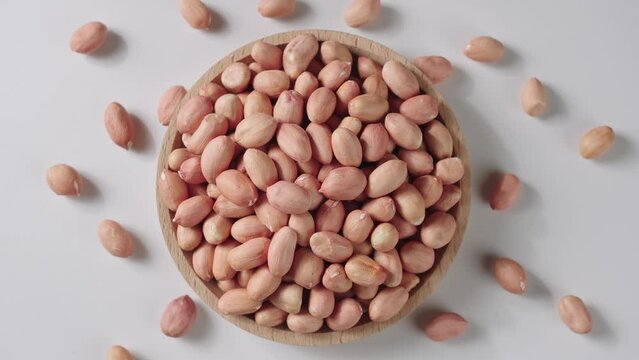 peeled raw peanut kernel on white background.