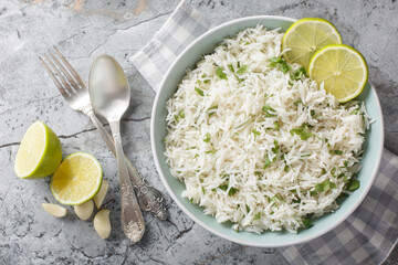 Organic cilantro lime rice with garlic and zest close-up in a bowl on the table. Horizontal top...