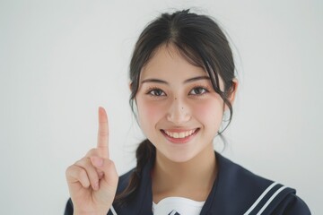 指をさす日本人の女子高生（白背景・案内・受験案内）