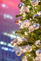 Christmas tree with a  building in background, New York City at night