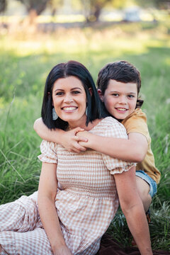 Portrait of mother and son sitting together in Australian bush setting
