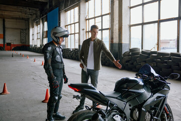 First driving lesson at motorcycle school in indoor motordrome