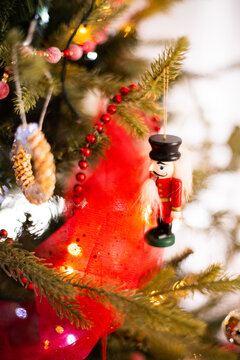 nutcracker ornament hanging from a Christmas tree