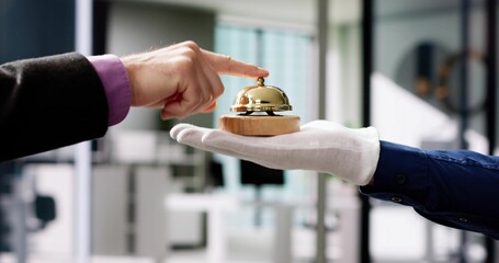 Person's Hand Ringing Service Bell Hold