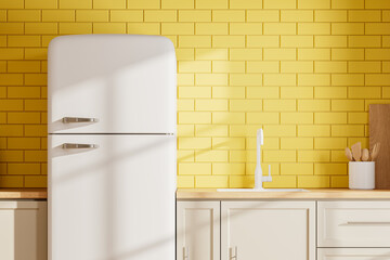 Yellow home kitchen interior with cooking cabinet and refrigerator
