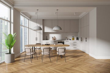 Modern home kitchen interior with eating table and cabinet, panoramic window