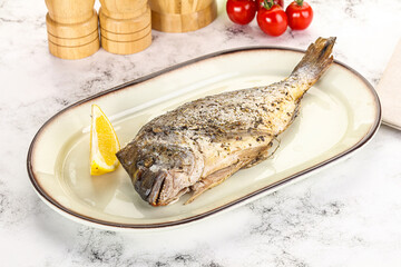 Baked Dorado fish served lemon