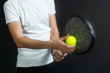 Paddle tennis player ready for serve on gray background