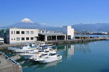 Fuji Mountain and Fisherman boats with Japan industry factory area background view from Tagonoura...