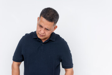 Middle-aged Asian man looking down with a guilty expression, conveying regret. Solemn mood, isolated on a white background.