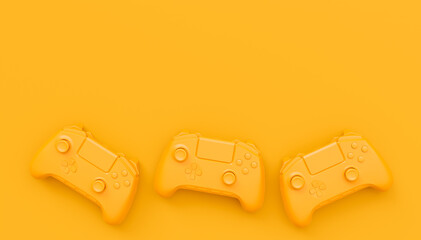 Video game joysticks or gamepads in plain monochrome yellow color background © Vasyl Onyskiv