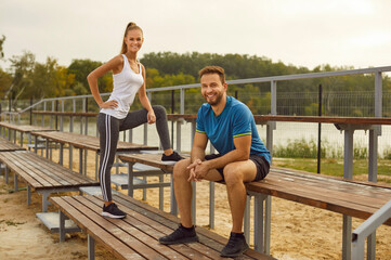 Radiant sport couple embraces an active lifestyle during a workout session in the park. Against the...