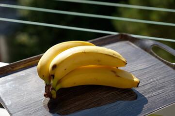 Beautiful fresh yellow banana on the table. Healthy food - fruit for a snack.