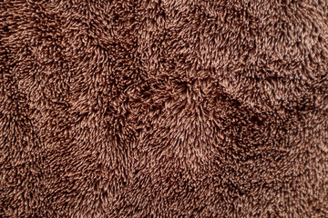 Brown fur towel texture. Soft towel surface detail