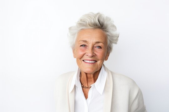 Portrait of a senior woman smiling at the camera on a white background