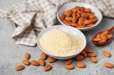 Fresh almond flour in a  bowl and almonds
