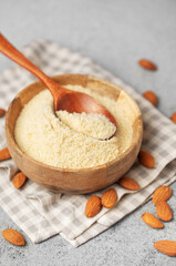 Fresh almond flour in a  bowl and almonds