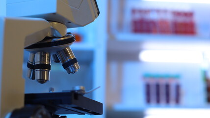 Scientists are doing research in a science lab. A medical chemist in a white coat, gloves and...