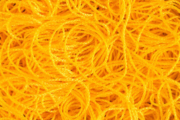 Chaotic lying yellow cord, abstract background pattern