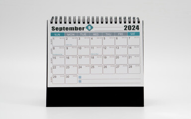 Desk or portable calendar. September page of a table calendar displayed on white background.  - obrazy, fototapety, plakaty