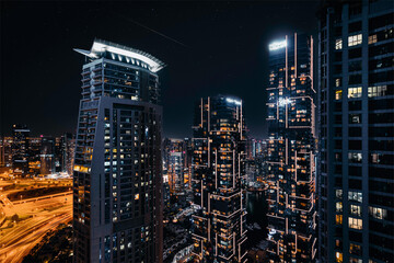 High Rise Buildings during Night Time Dubai, United Arab Emirates.
 - Powered by Adobe