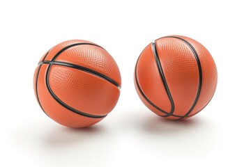 Fototapeta premium A pair of orange basketball balls on a white surface. Perfect for sports-related designs and concepts
