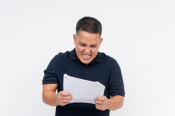 Annoyed adult man expressing anger after reading an unfair notice, rejected policy, or document...