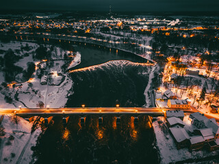 Aerial view on the old brick bridge and river in the night time in unesco city in europe