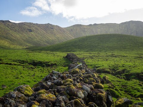 Stone wall across the green fields of the volcanic crater of Caldeir&atilde;o do Corvo