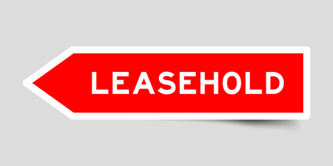 Red color arrow shape sticker label with word leasehold on gray background