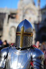 knight with steel armor and helmet to protect his head and old palace in background