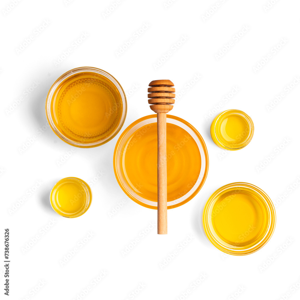 Wall mural Honey in bowls and dipper on a white background top view.