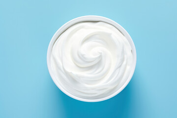 Creamy Delights: Wholesome White Yogurt, a Fresh and Natural Dairy Product, on a Hygienic Blue Background