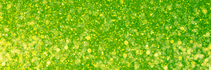 Abstract green trendy backdrop. Sparkling background made of lights. Festive blurred banner