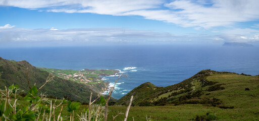 Panorama of Flores Island landscape with Ponta Delgada village and Corvo Island across the canal