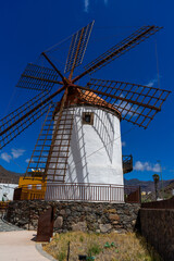 An old Wind Mill and some oversized pots cans coffee grinders in Mogan on Gran Canaria Island...