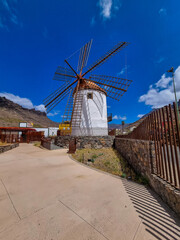 An old Wind Mill and some oversized pots cans coffee grinders in Mogan on Gran Canaria Island...