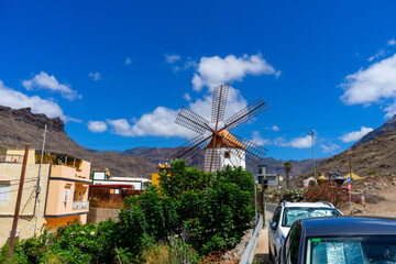 An old Wind Mill and some oversized pots cans coffee grinders in Mogan on Gran Canaria Island...