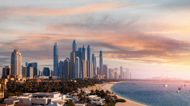 Aerial top view Dubai, panoramic of Marina and JBR sand beaches, sunset time. Downtown of UAE with modern futuristic skyscraper
