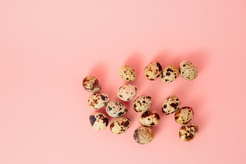 Quail eggs on pink background. Copy space. Farm product. Empty text place. Mockup design of Easter holiday decoration. Healthy food