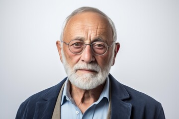 Portrait of a senior man with grey beard and eyeglasses