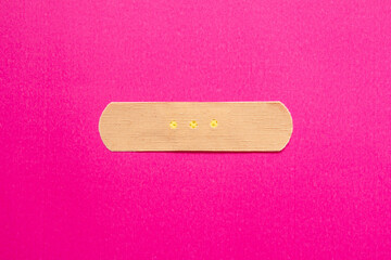 Medical plaster isolated on pink background. Top view, copy space.