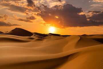 Sunset over the sand dunes in the desert. Rub' al Khali desert - obrazy, fototapety, plakaty