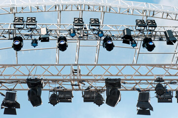 Scaffolding above the stage with lamps for the lighting effects of the outdoor concert.