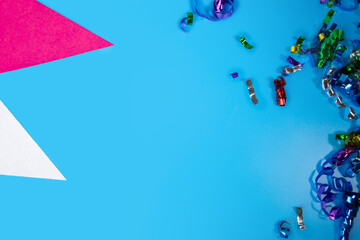 Carnival confetti and holiday flags on blue background, joyful party decorations, festive garlands