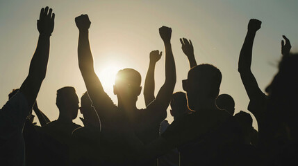 Silhouette of fans cheering at a football game.
