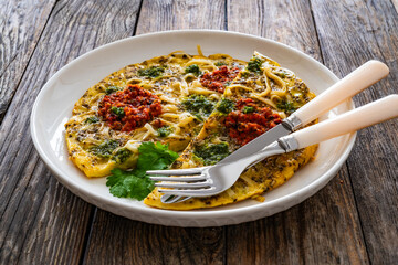 Tagliatelle omelet - scrambled eggs with mozzarella cheese, tagliatelle, basil and tomato pesto on...