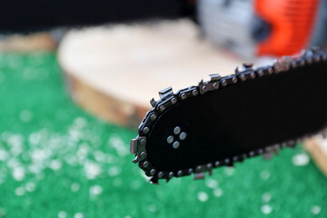Close-up of woodcutter sawing chain saw blade. Portable gasoline chainsaw.Selective focus.