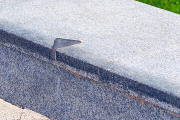 Anti-skateboarding devices on a stone fence. Anti roller spike