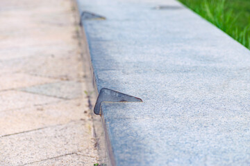 Anti-skateboarding devices on a stone fence. Anti roller spike